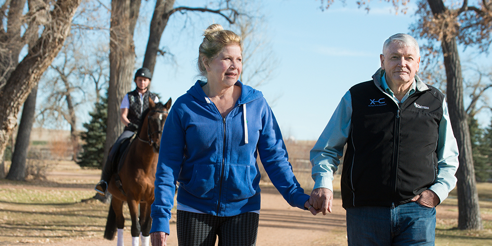 Leslie and John Malone walk at Harmony Sporthorses, December 2, 2014.